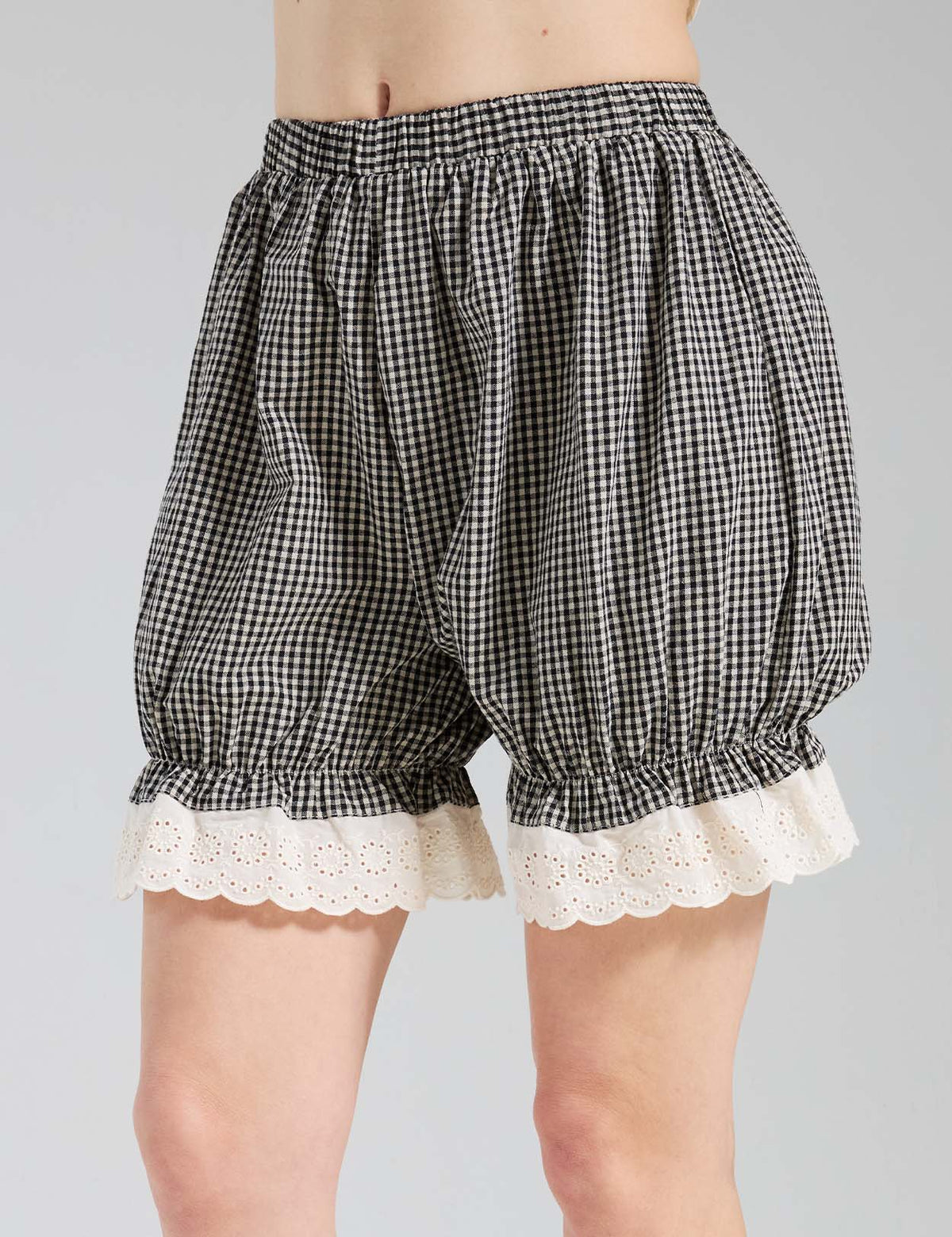 Close-up of Beautelicate gingham bloomers showing eyelet lace cuff and elastic waistband detail