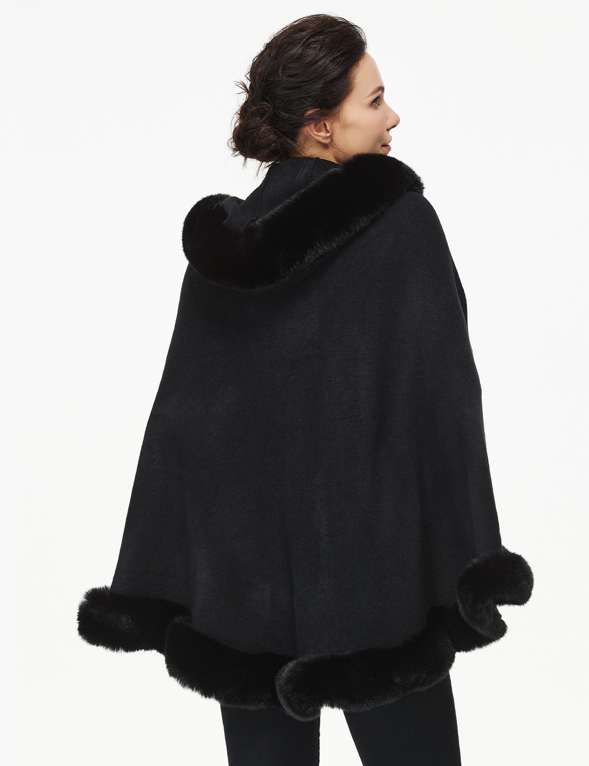 Women's faux fur poncho with hood showing elegant drape and texture