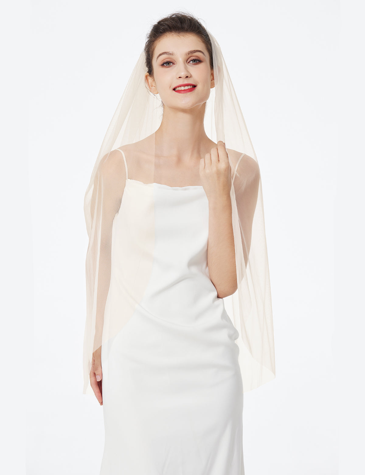 Bride wearing fingertip length wedding veil demonstrating elegant drape and movement