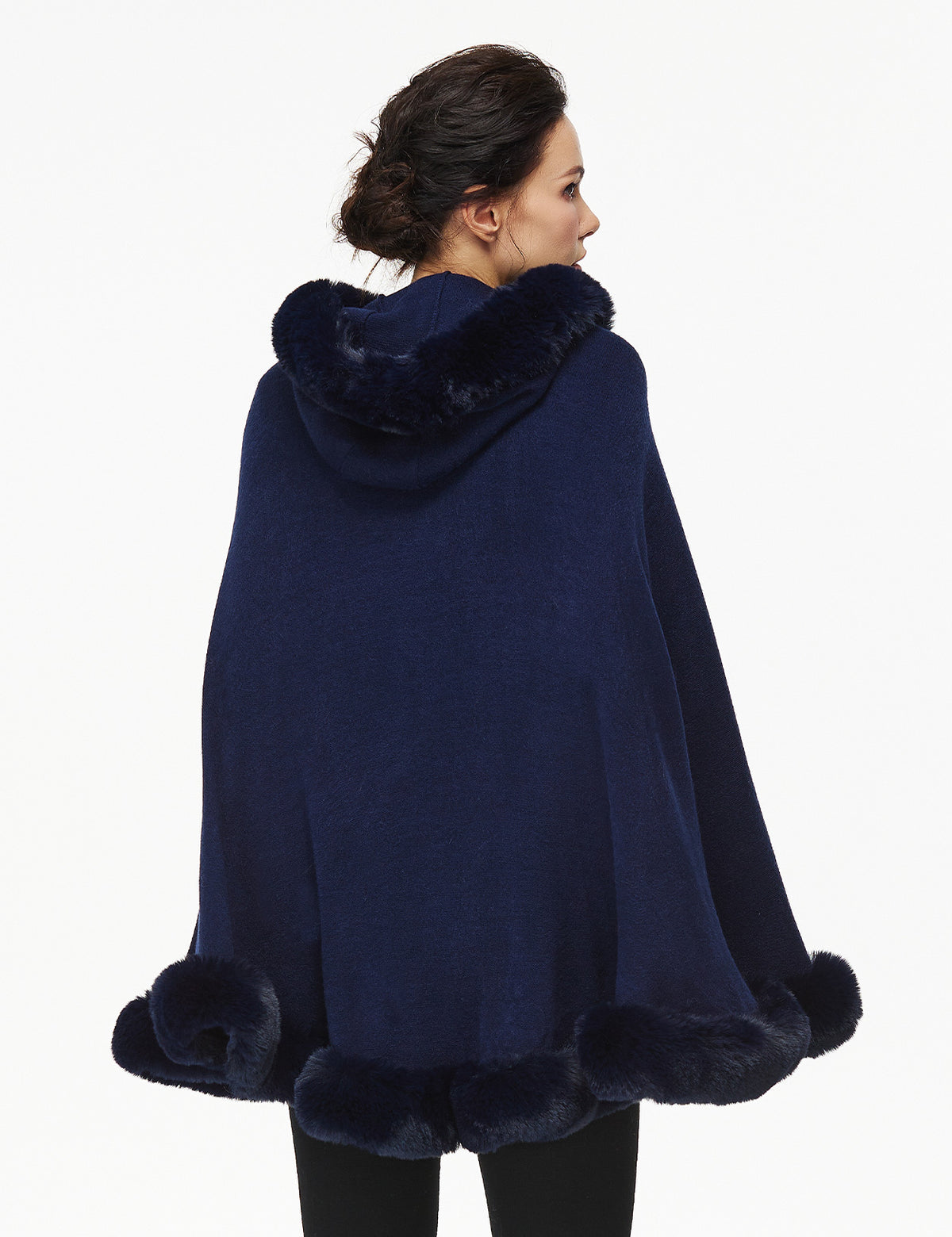 Women's faux fur poncho with hood showing elegant drape and texture