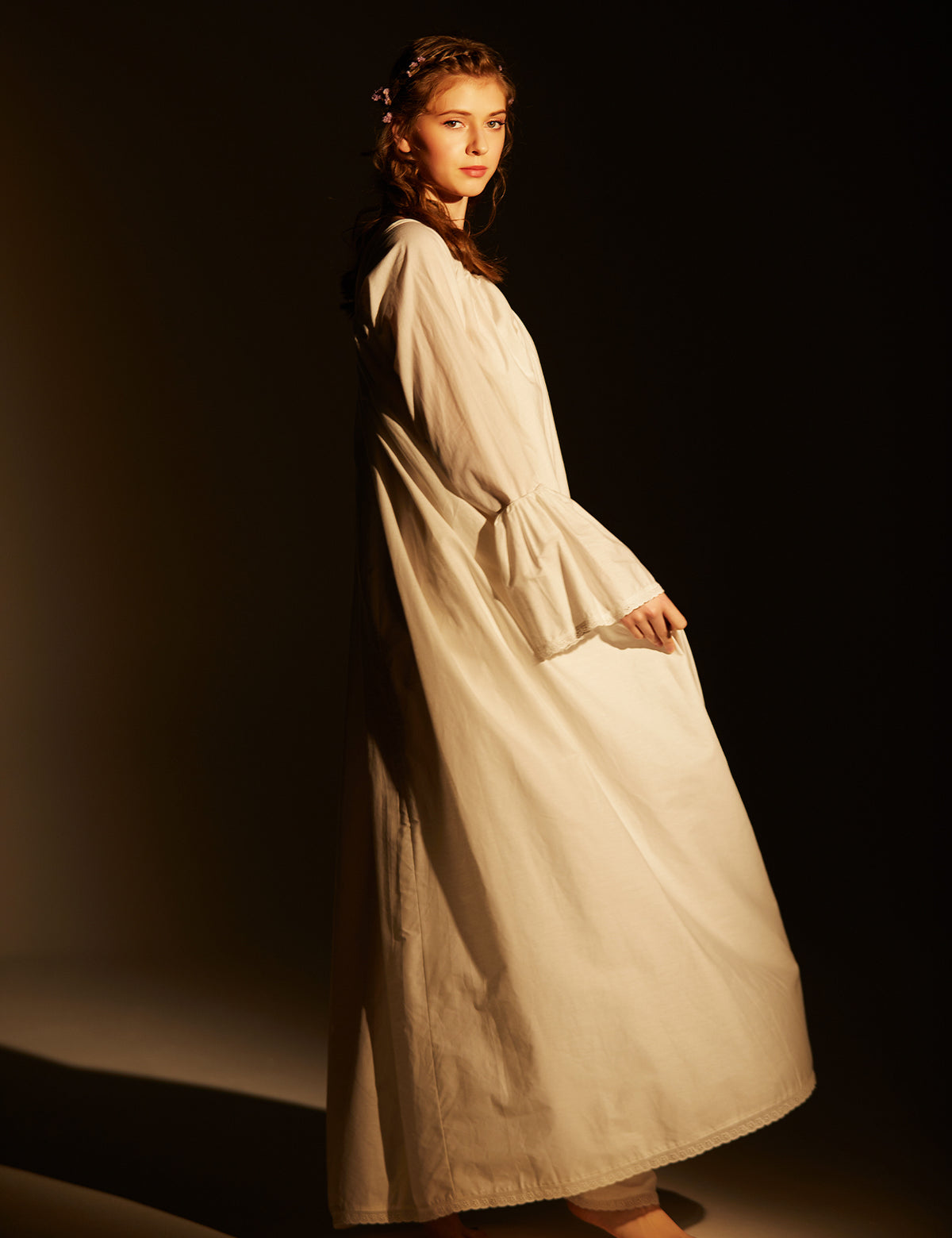 Side profile of Victorian nightgown highlighting the flowing bell sleeve silhouette and comfortable fit