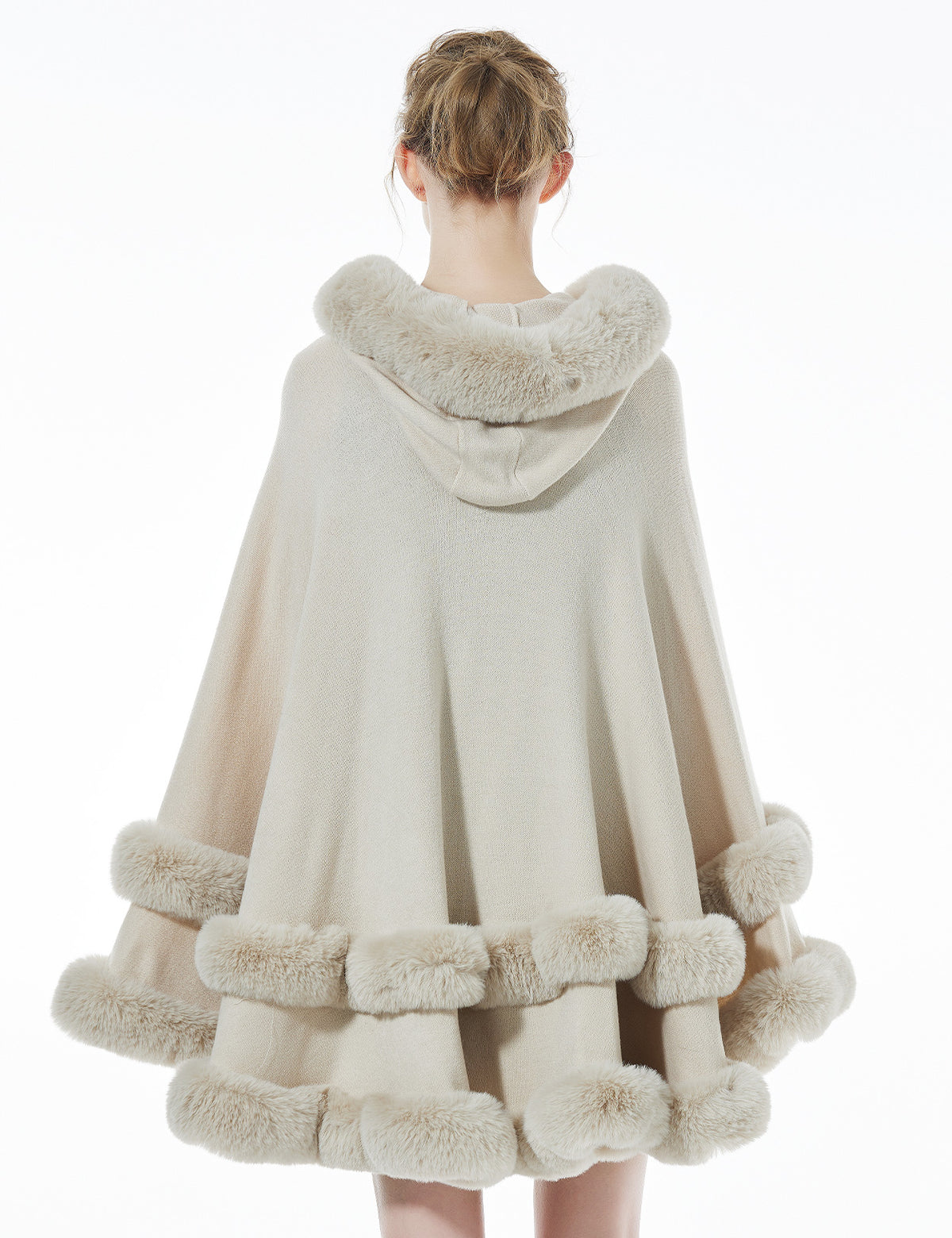 Women's beige hooded knit cape back view showing faux fur trim and flowing silhouette