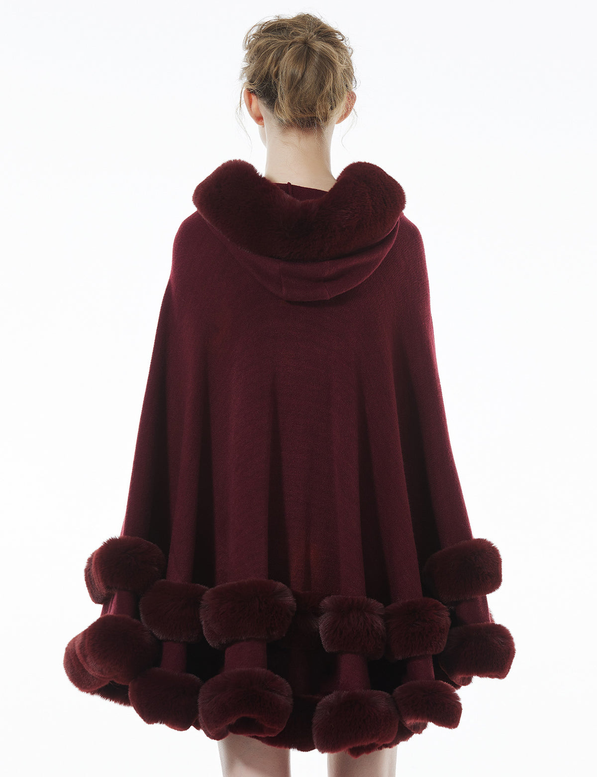 Back view of burgundy hooded knit cape highlighting rich color and flowing cape silhouette