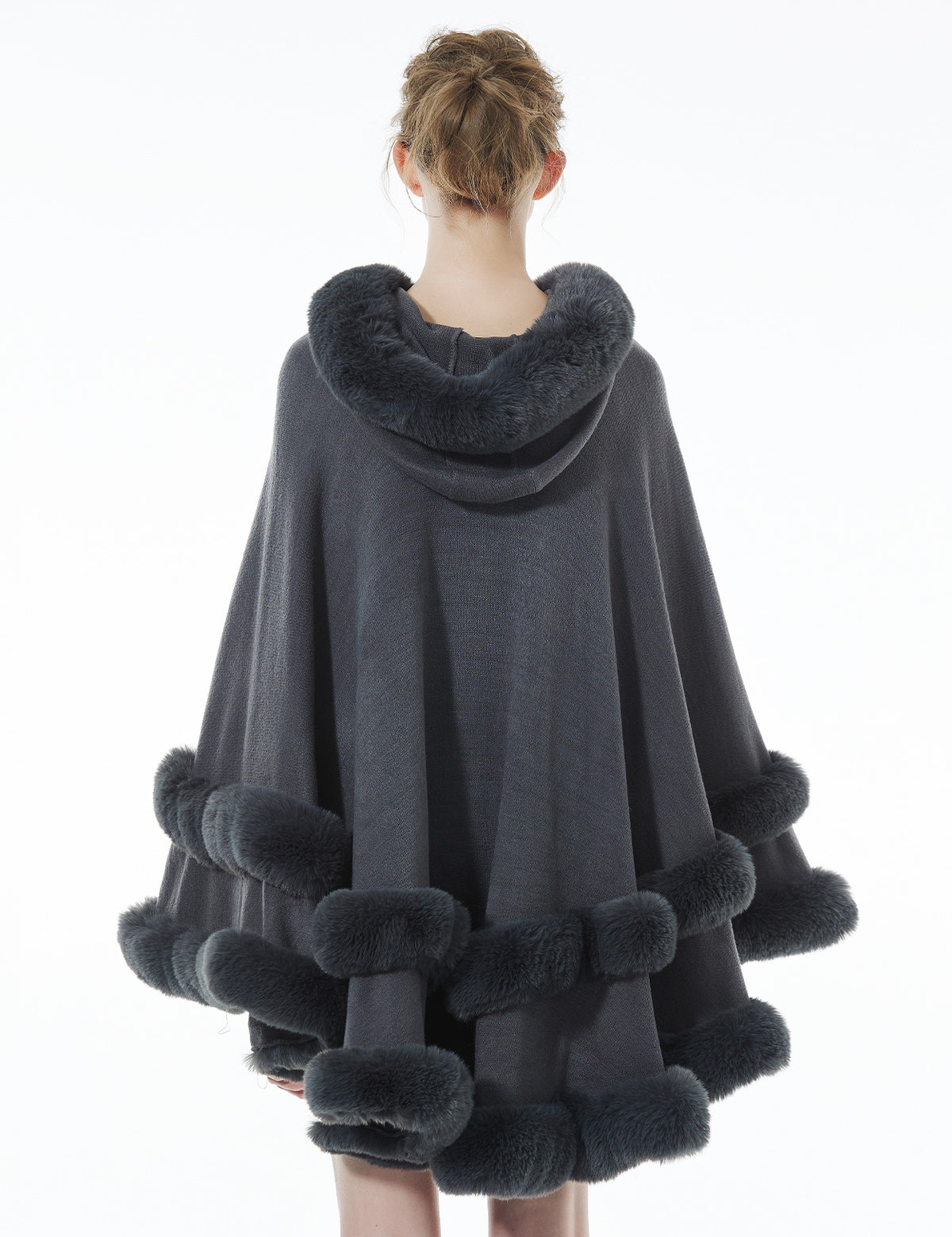 Back view of stonegrey hooded knit cape displaying flowing silhouette and faux fur hood detail