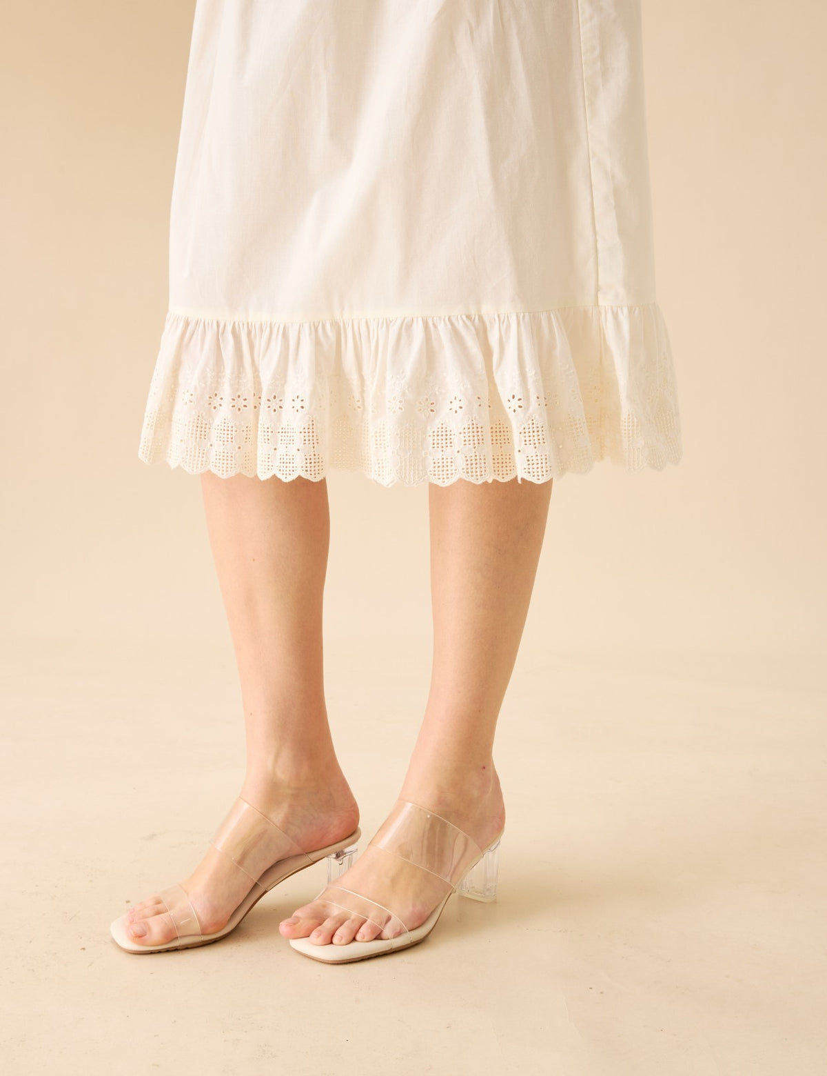 Close-up detail of the eyelet lace ruffle on a cream cotton half slip.
