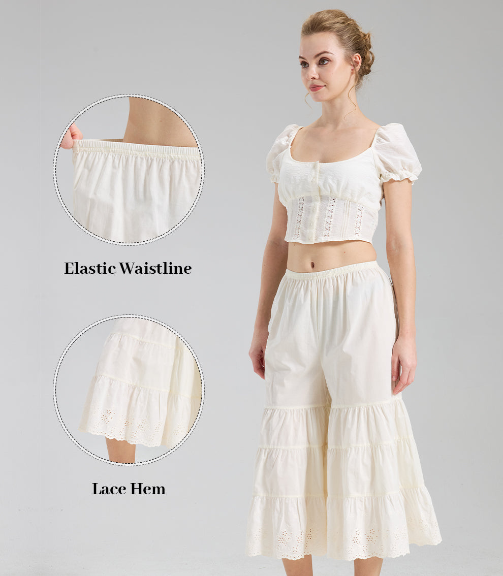 Close-up details of cream bloomers highlighting the stretchy elastic waistline and intricate scalloped eyelet lace.
