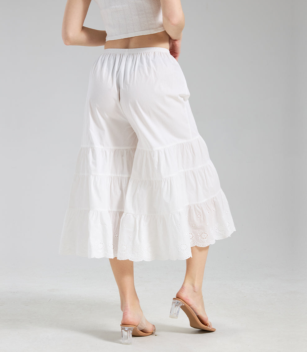 Back view of ivory cotton culottes with clean tiered structure and eyelet lace hem.