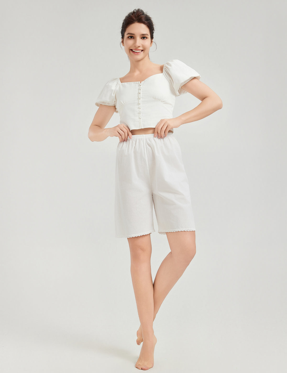 Model wearing white cotton pettipants with lace trim, showing comfortable loose fit and knee length