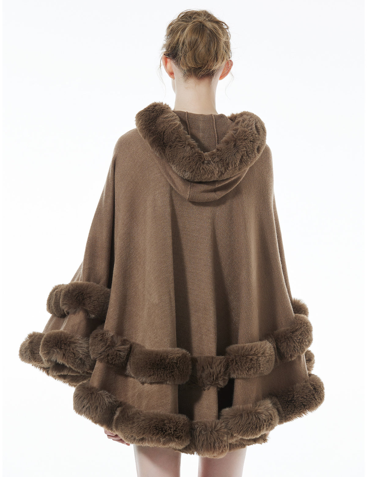 Back view of khaki hooded knit cape displaying flowing silhouette and faux fur hood detail